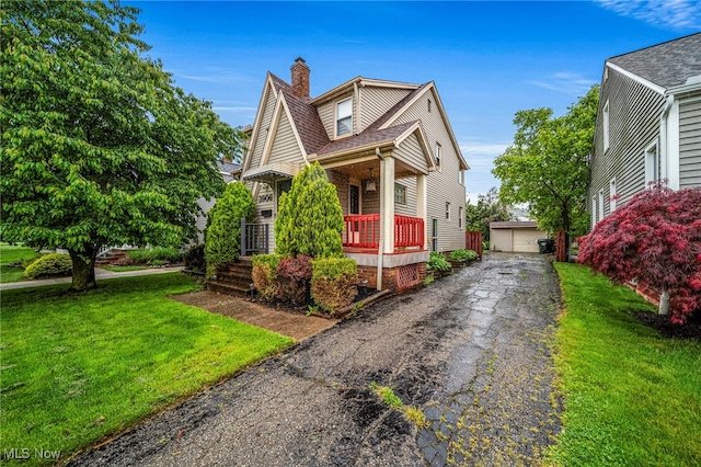 3906 Redfern Rd, Parma, OH 44134 - view of front of property with a porch, a chimney, a front yard, and an outdoor structure