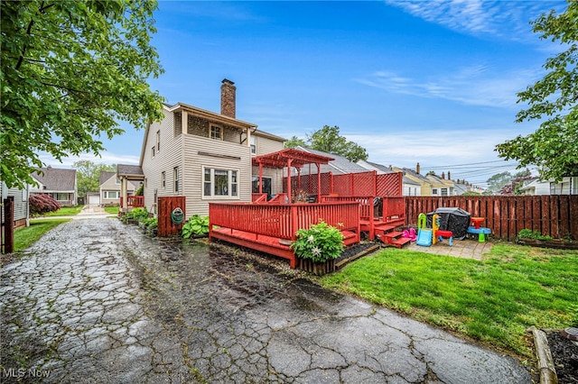 3906 Redfern Rd, Parma, OH 44134 - rear view of house with a chimney and a deck