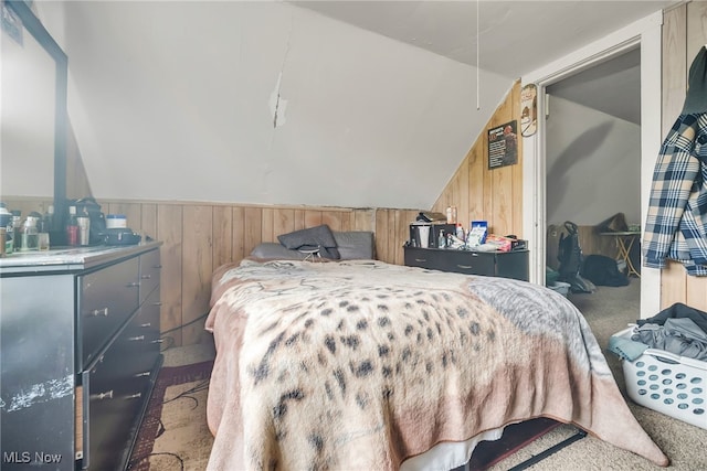 11020 Woodstock Ave, Cleveland, OH 44104 - bedroom with wooden walls, lofted ceiling, and carpet flooring