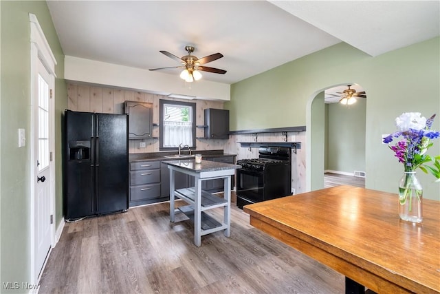 321 Cornell Ave, Youngstown, OH 44507 - kitchen featuring black appliances, a sink, ceiling fan, dark countertops, and arched walkways