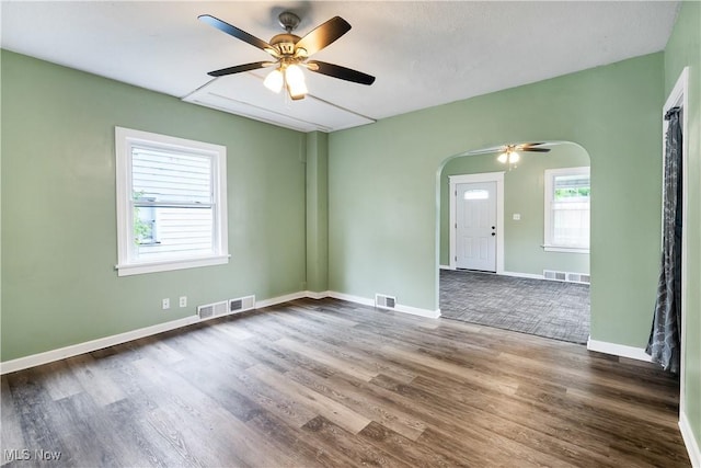 321 Cornell Ave, Youngstown, OH 44507 - unfurnished room featuring arched walkways, a ceiling fan, wood finished floors, and baseboards