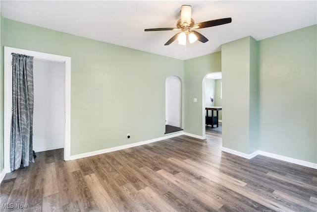321 Cornell Ave, Youngstown, OH 44507 - empty room with arched walkways, wood finished floors, a ceiling fan, and baseboards