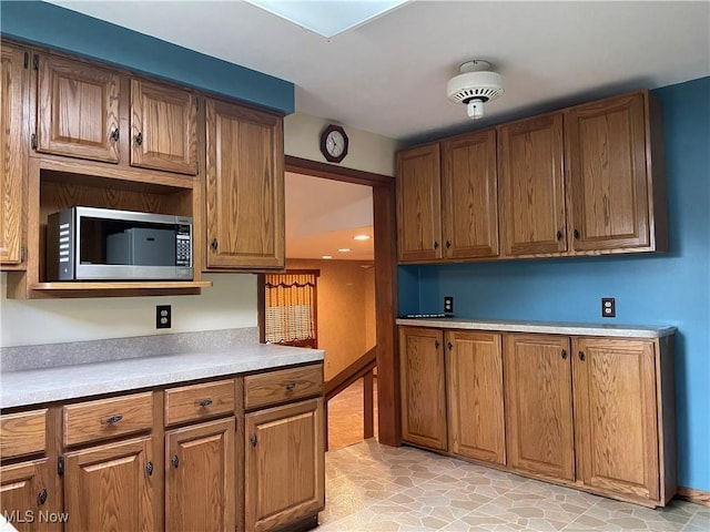 29000 Norman Ave, Wickliffe, OH 44092 - kitchen featuring stainless steel microwave, brown cabinetry, and light countertops