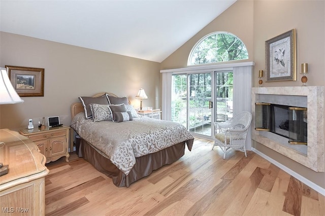 3691 Lexington Ct, Westlake, OH 44145 - bedroom featuring light wood-type flooring, high vaulted ceiling, a fireplace, and access to exterior