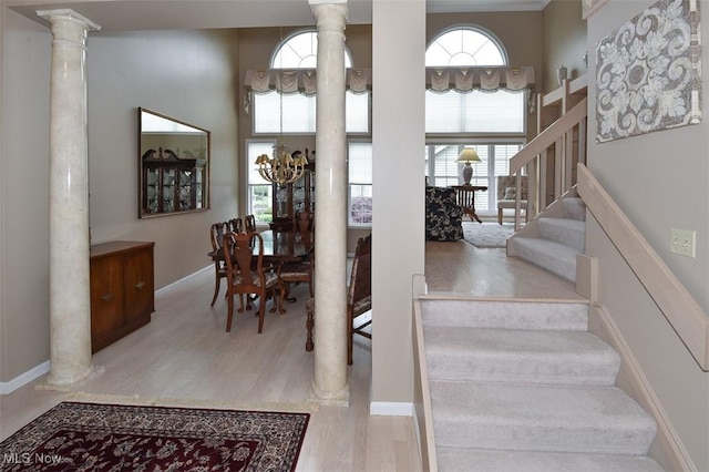 3691 Lexington Ct, Westlake, OH 44145 - staircase featuring ornate columns, wood finished floors, a chandelier, and baseboards