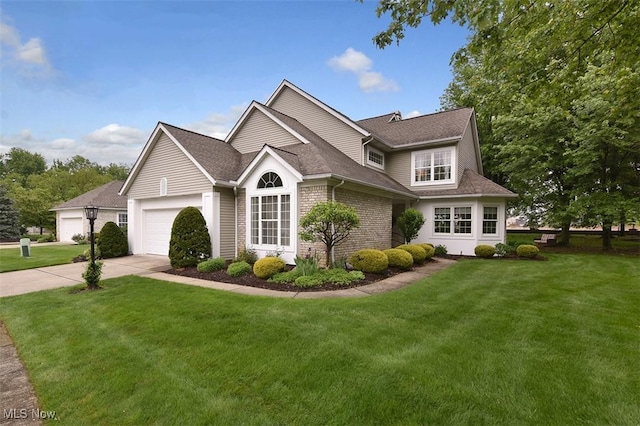 3691 Lexington Ct, Westlake, OH 44145 - traditional home with driveway, an attached garage, a front yard, and brick siding
