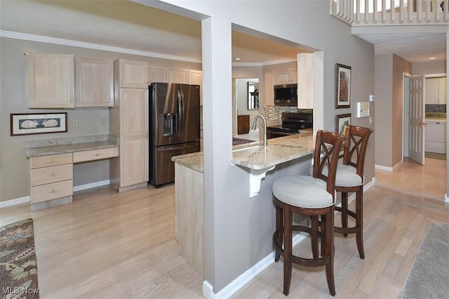 3691 Lexington Ct, Westlake, OH 44145 - kitchen featuring appliances with stainless steel finishes, backsplash, baseboards, and crown molding