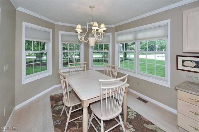 3691 Lexington Ct, Westlake, OH 44145 - dining space featuring plenty of natural light, light wood-style flooring, a chandelier, and crown molding