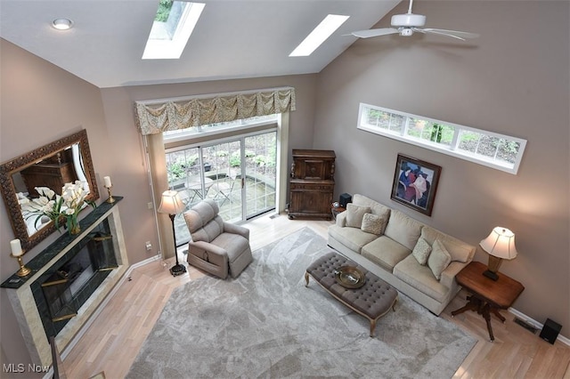 3691 Lexington Ct, Westlake, OH 44145 - living room with a skylight, wood finished floors, ceiling fan, baseboards, and high vaulted ceiling