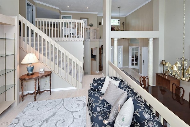 3691 Lexington Ct, Westlake, OH 44145 - stairway with wood finished floors, ornamental molding, a chandelier, a high ceiling, and decorative columns