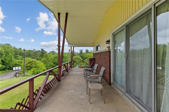 68951 Pine Terrace Rd, Bridgeport, OH 43912 - view of patio with a balcony and a wooded view