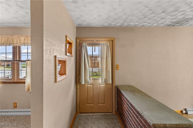 68951 Pine Terrace Rd, Bridgeport, OH 43912 - doorway with a baseboard heating unit, baseboards, and a textured ceiling