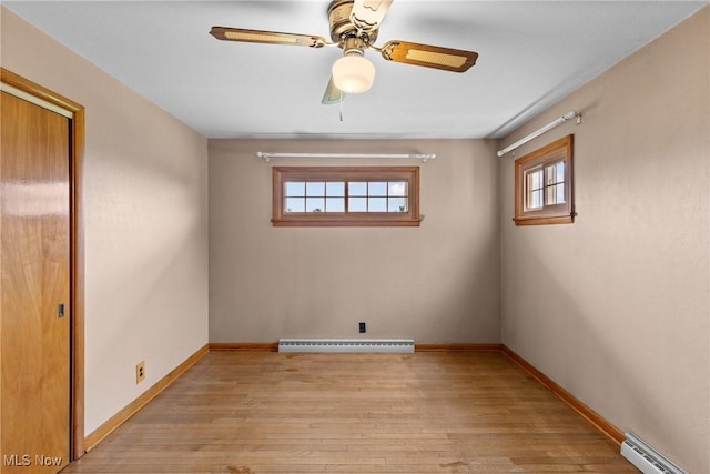 68951 Pine Terrace Rd, Bridgeport, OH 43912 - empty room featuring baseboard heating, light wood finished floors, baseboards, and a ceiling fan