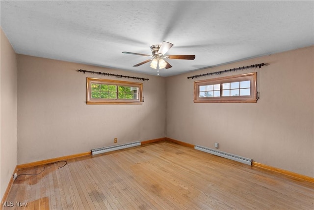 68951 Pine Terrace Rd, Bridgeport, OH 43912 - empty room featuring a baseboard heating unit, baseboard heating, and baseboards
