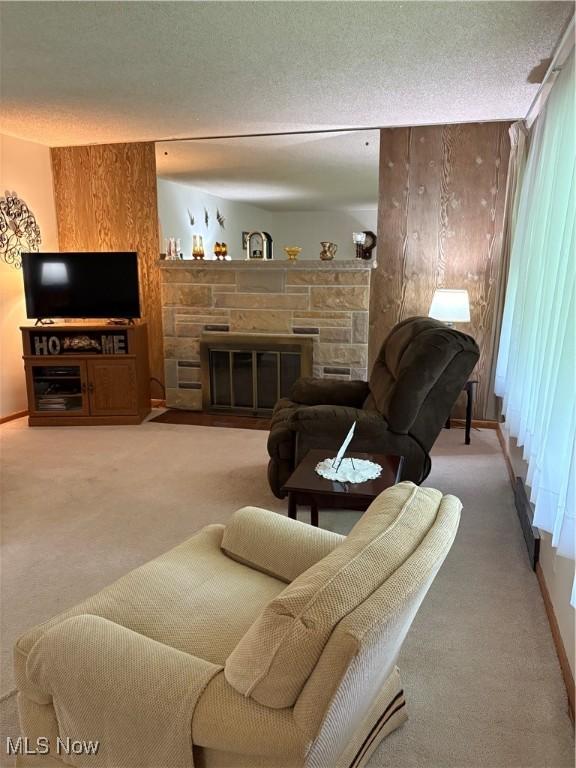 2499 Nesmith Lake Blvd, Akron, OH 44314 - living area with carpet flooring, a fireplace, baseboards, and a textured ceiling