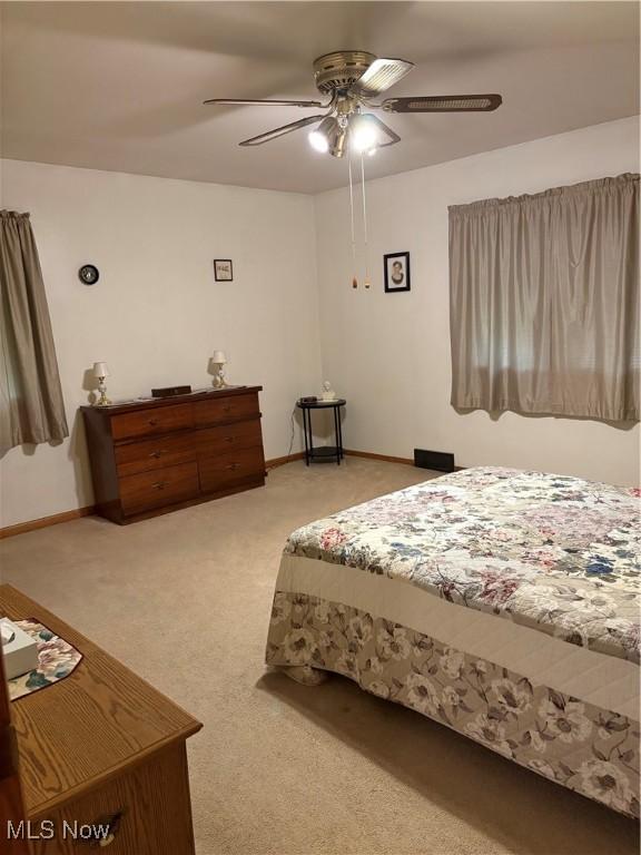 2499 Nesmith Lake Blvd, Akron, OH 44314 - bedroom featuring light carpet, baseboards, and a ceiling fan