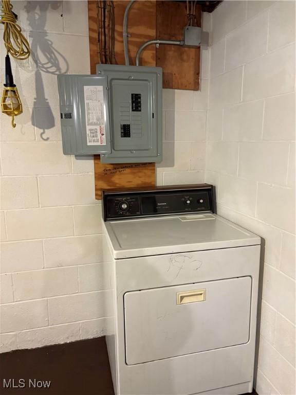 2499 Nesmith Lake Blvd, Akron, OH 44314 - laundry room with washer / dryer, electric panel, and concrete block wall