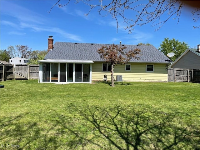 2733 W 37th St, Lorain, OH 44053 - rear view of property featuring a sunroom, a chimney, central air condition unit, roof with shingles, and a gate