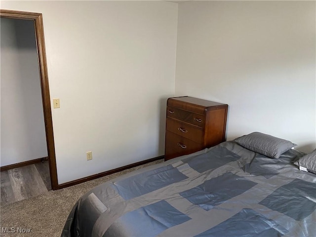 2733 W 37th St, Lorain, OH 44053 - carpeted bedroom featuring baseboards and wood finished floors