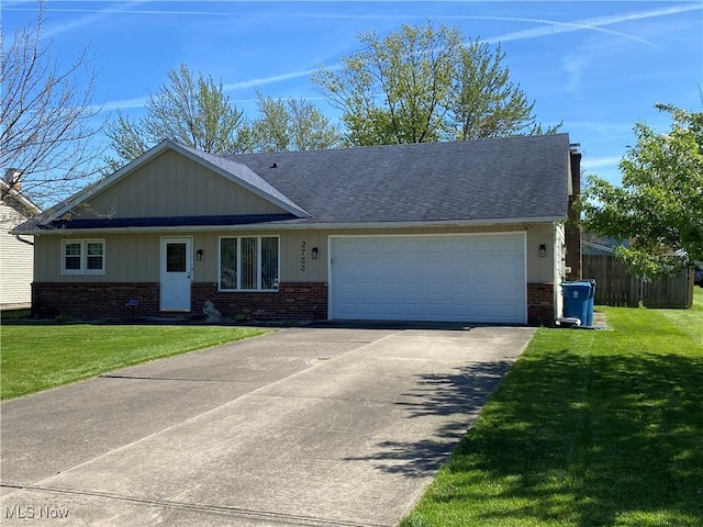 2733 W 37th St, Lorain, OH 44053 - ranch-style home featuring brick siding, a garage, driveway, and a shingled roof
