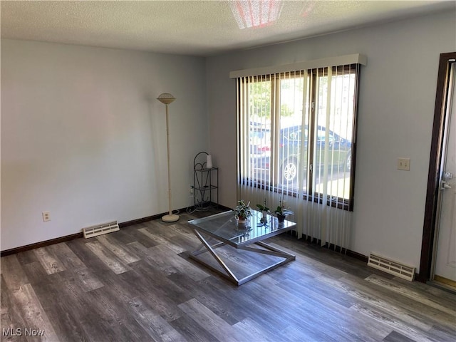 2733 W 37th St, Lorain, OH 44053 - unfurnished room with wood finished floors, a textured ceiling, and baseboards