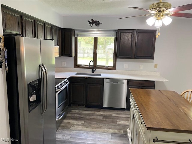 2733 W 37th St, Lorain, OH 44053 - kitchen with appliances with stainless steel finishes, a sink, butcher block countertops, a ceiling fan, and light wood-style floors