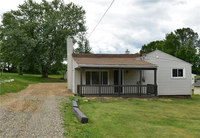 5308 Walters St NE, East Canton, OH 44730 - view of front of home with a chimney, a front lawn, and roof with shingles