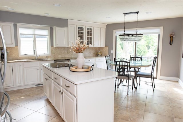 30907 Arlington Cir, Bay Village, OH 44140 - kitchen featuring a sink, decorative backsplash, white cabinets, and recessed lighting