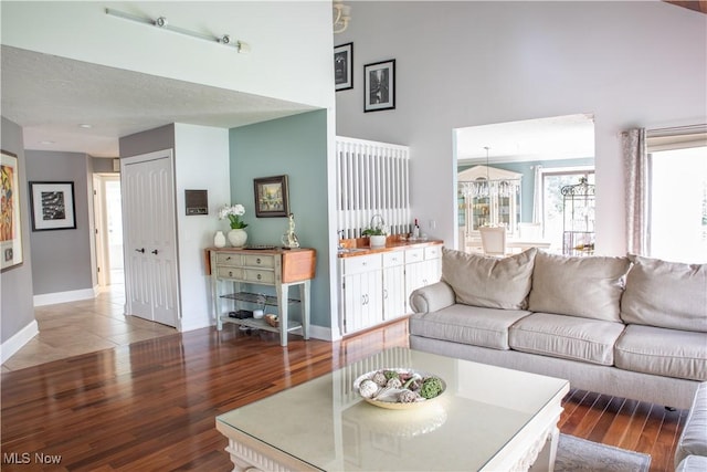 30907 Arlington Cir, Bay Village, OH 44140 - living room featuring a towering ceiling, baseboards, plenty of natural light, and wood finished floors