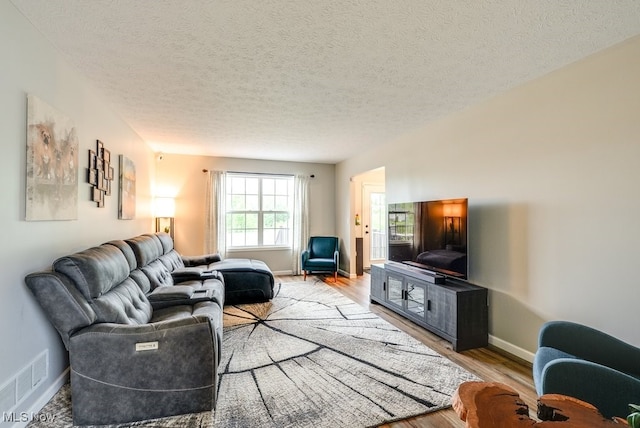 2042 Summer Evening Dr, Canal Fulton, OH 44614 - living room with light wood-type flooring, baseboards, and a textured ceiling