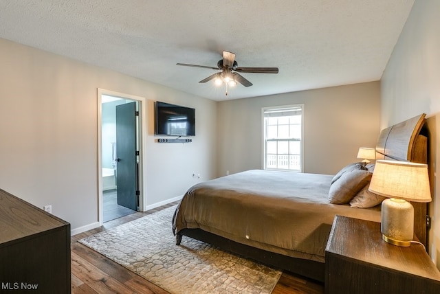 2042 Summer Evening Dr, Canal Fulton, OH 44614 - bedroom with wood finished floors, baseboards, ensuite bath, and a ceiling fan