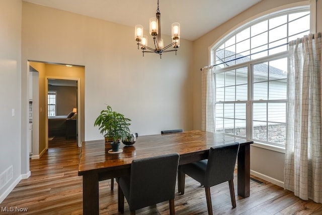 2042 Summer Evening Dr, Canal Fulton, OH 44614 - dining space featuring a chandelier, baseboards, and light wood-style flooring