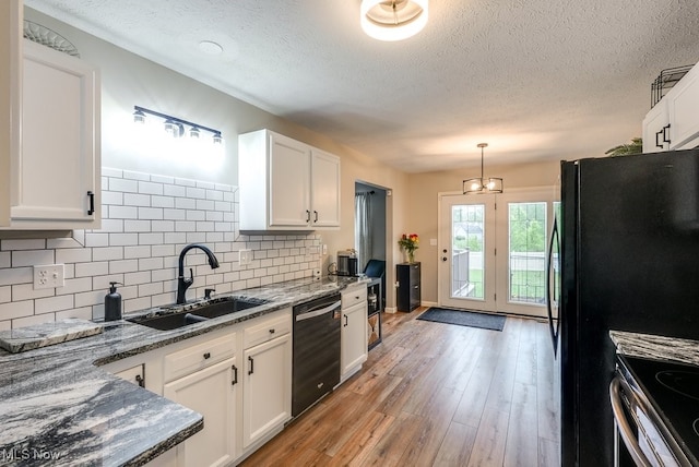 2042 Summer Evening Dr, Canal Fulton, OH 44614 - kitchen featuring black dishwasher, a sink, white cabinetry, a textured ceiling, and backsplash