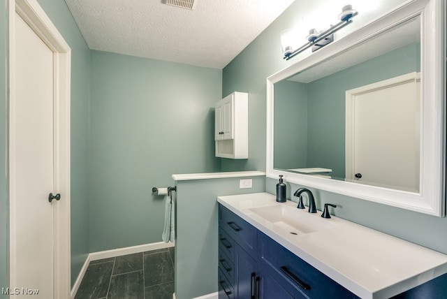 2042 Summer Evening Dr, Canal Fulton, OH 44614 - bathroom with vanity, baseboards, a textured ceiling, toilet, and marble finish flooring