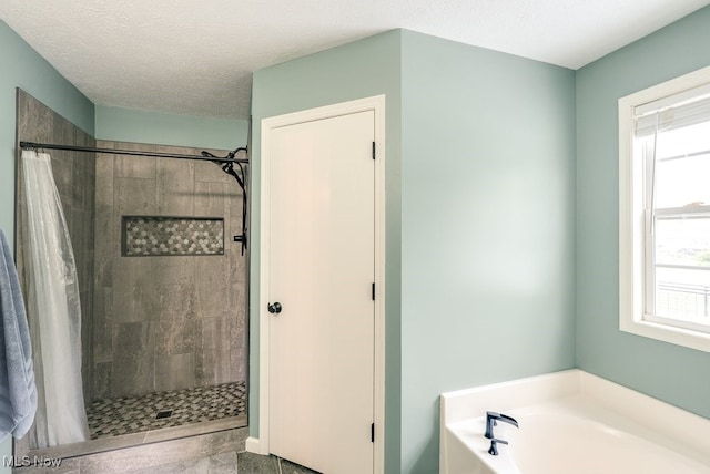 2042 Summer Evening Dr, Canal Fulton, OH 44614 - full bathroom featuring a garden tub, a shower stall, and a textured ceiling