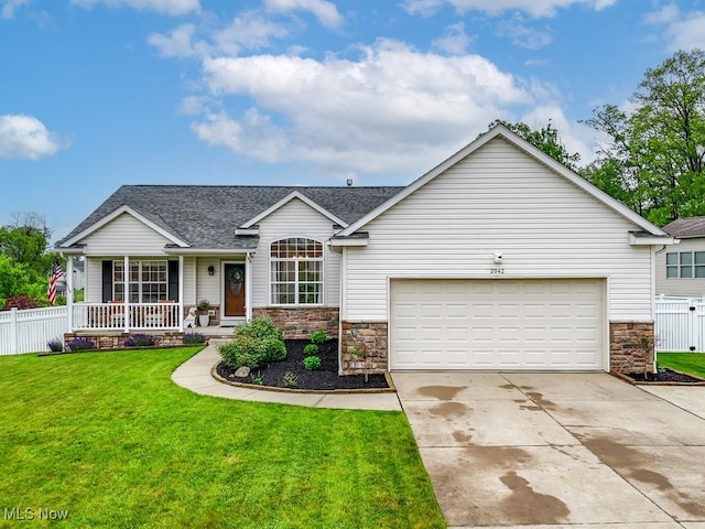 2042 Summer Evening Dr, Canal Fulton, OH 44614 - view of front of property featuring driveway, a garage, covered porch, a shingled roof, and stone siding