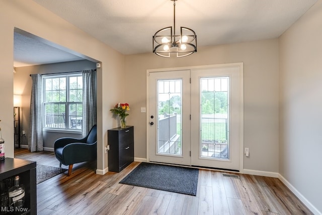 2042 Summer Evening Dr, Canal Fulton, OH 44614 - entryway with a chandelier, wood finished floors, and baseboards