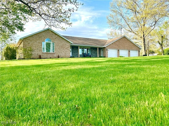 13946 Highview Dr, Dalton, OH 44618 - ranch-style home with brick siding, a garage, and a front lawn