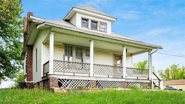 8045 Old Town Rd, East Fultonham, OH 43777 - view of front of property with a porch, a chimney, and central air condition unit