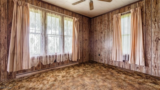 8045 Old Town Rd, East Fultonham, OH 43777 - carpeted empty room with ceiling fan, a baseboard heating unit, and wood walls