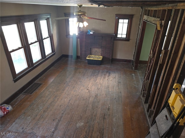 1119 W 11th St, Lorain, OH 44052 - unfurnished living room featuring hardwood / wood-style floors, a brick fireplace, ceiling fan, and baseboards
