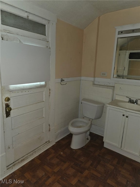 1119 W 11th St, Lorain, OH 44052 - bathroom featuring toilet, vanity, and wainscoting