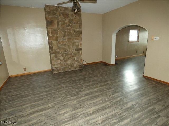 1020 Virginia St, Martins Ferry, OH 43935 - empty room featuring arched walkways, a ceiling fan, wood finished floors, and baseboards
