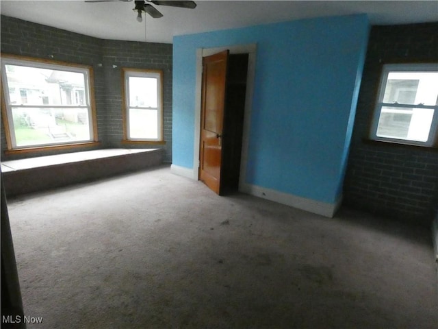 1020 Virginia St, Martins Ferry, OH 43935 - carpeted spare room with ceiling fan, brick wall, and baseboards
