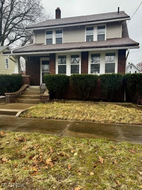 2231 13th St SW, Akron, OH 44314 - bungalow-style house featuring a chimney, brick siding, roof with shingles, and covered porch