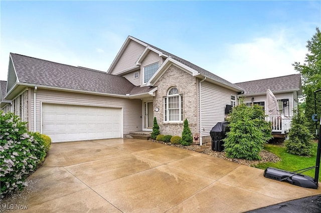 8550 Ivy Hill Dr Unit 16, Poland, OH 44514 - traditional home featuring an attached garage, concrete driveway, a shingled roof, and brick siding