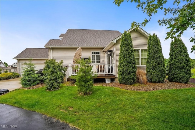 8550 Ivy Hill Dr Unit 16, Poland, OH 44514 - view of front of home featuring a garage, a front lawn, driveway, and a wooden deck