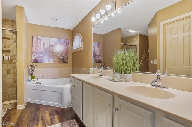 8550 Ivy Hill Dr Unit 16, Poland, OH 44514 - bathroom featuring a stall shower, a garden tub, double vanity, and wood finished floors