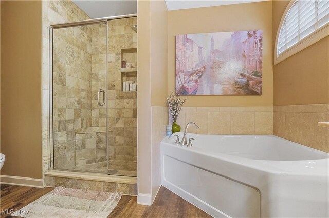 8550 Ivy Hill Dr Unit 16, Poland, OH 44514 - bathroom with a garden tub, a shower stall, toilet, and wood finished floors