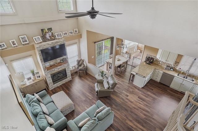 8550 Ivy Hill Dr Unit 16, Poland, OH 44514 - living area with a towering ceiling, ceiling fan, dark wood-type flooring, and a fireplace